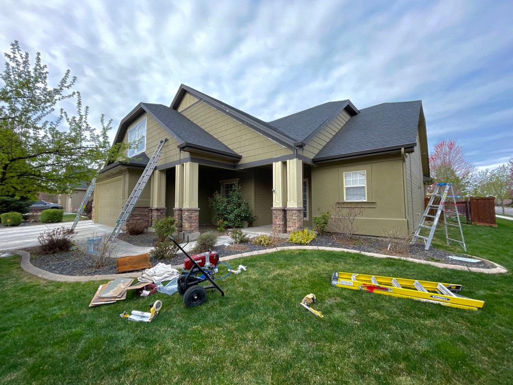 green yard home with new exterior paint