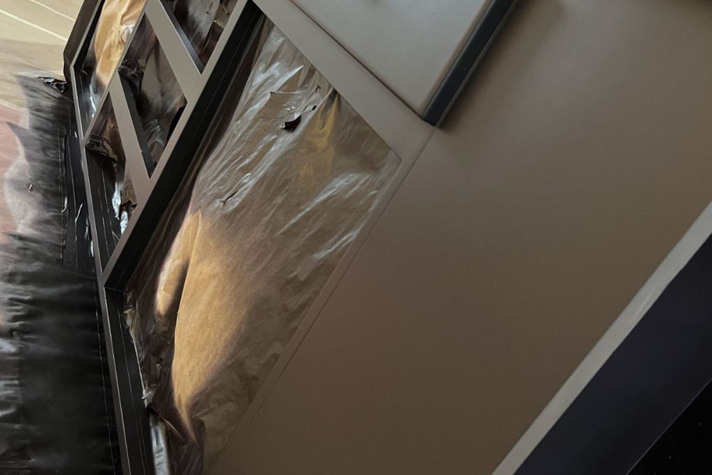 Window frame covered with protective plastic.