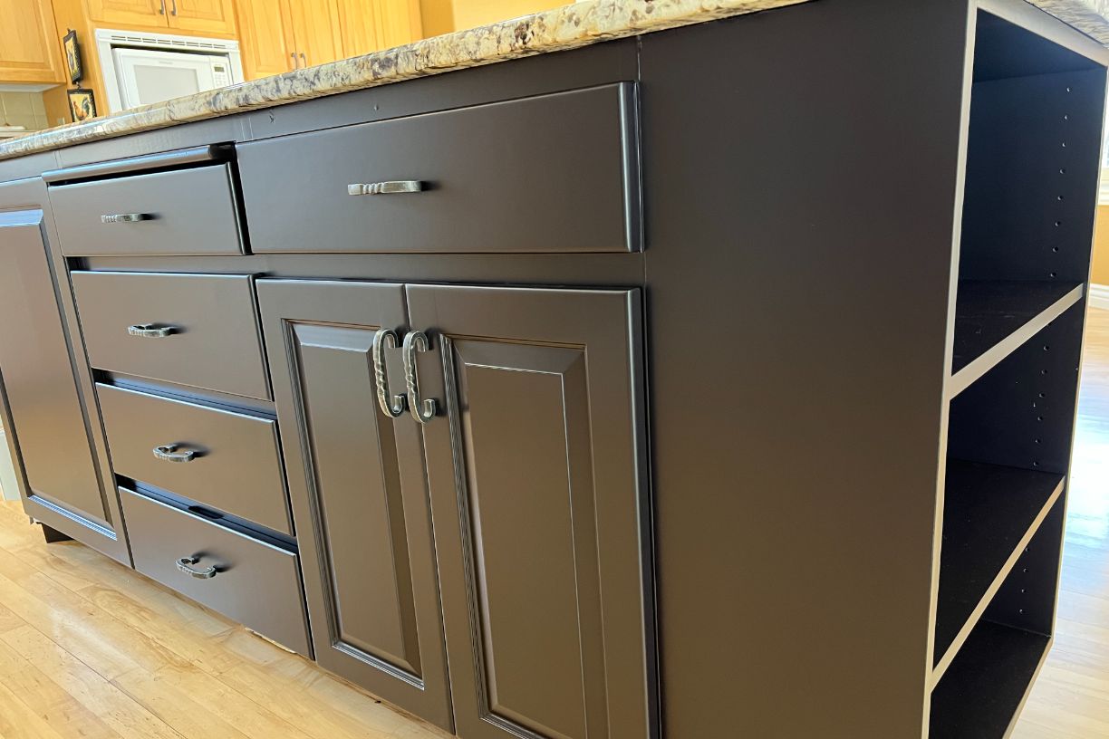 Close-up of kitchen island with drawers and cabinet details
