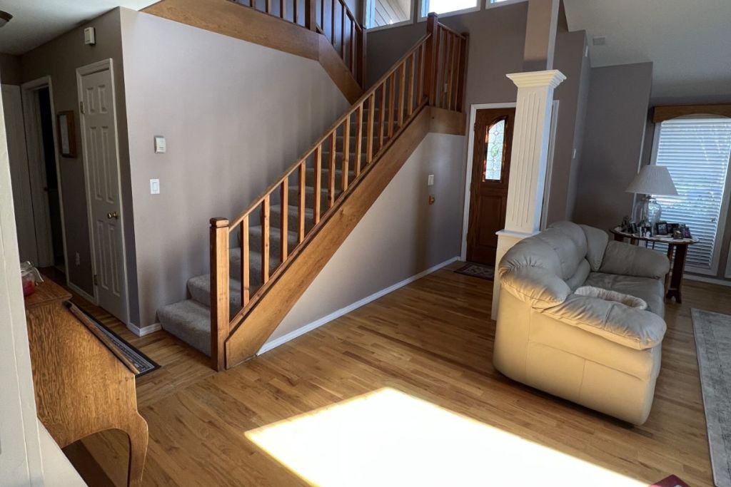 Freshly painted stairs and bright living room