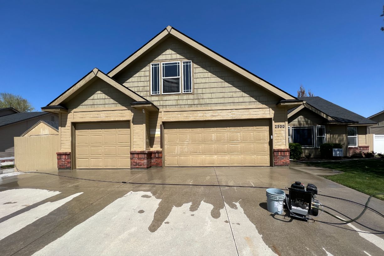 House with double garage and driveway being cleaned