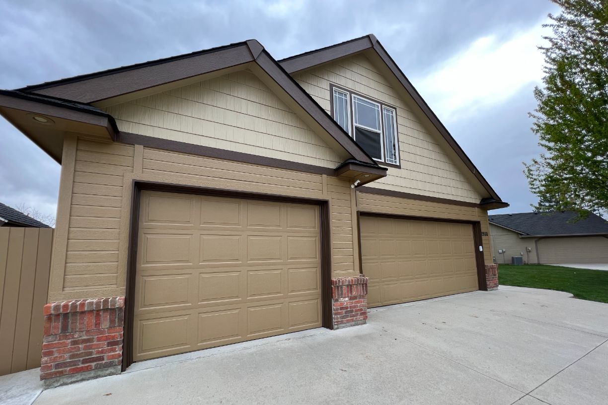 Side view of house with double garage doors