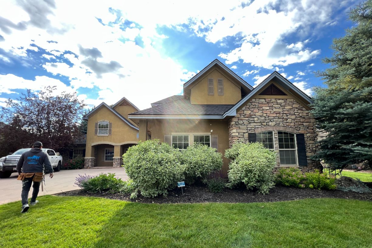 Painter walking toward freshly finished home