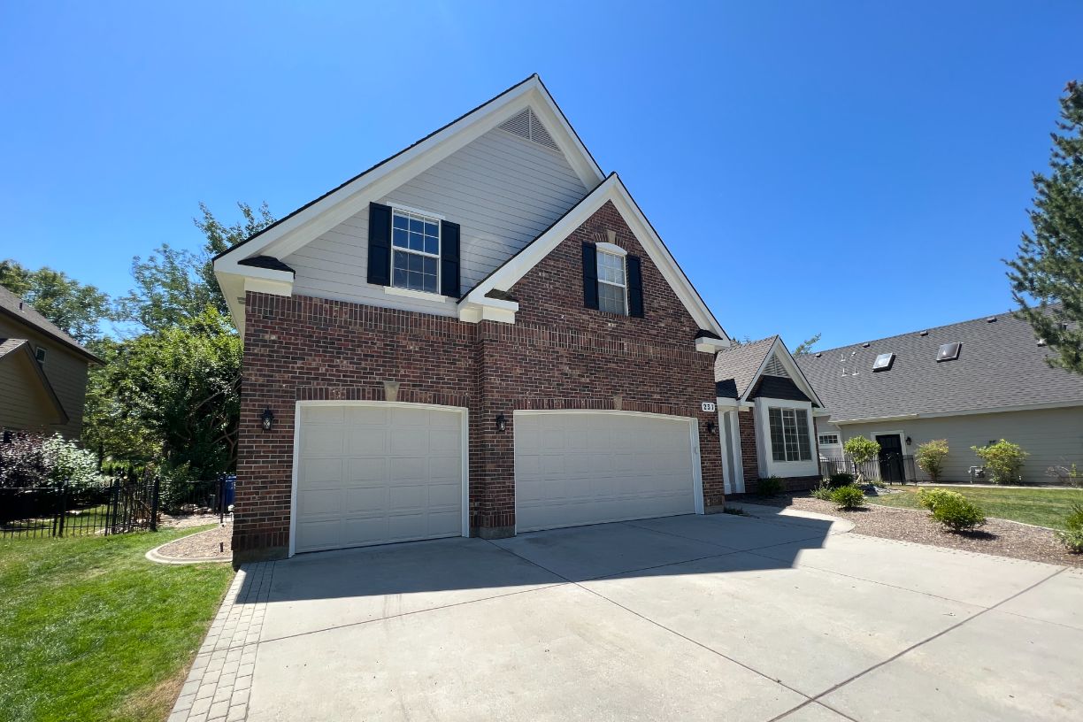 Brick exterior home with clean driveway