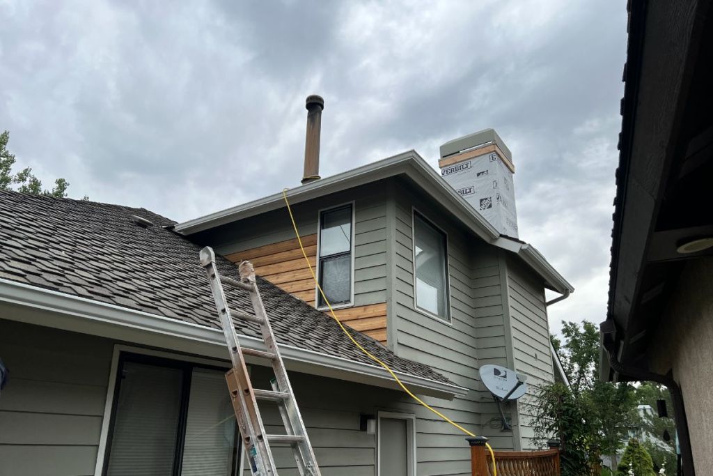Chimney repair and siding replacement underway