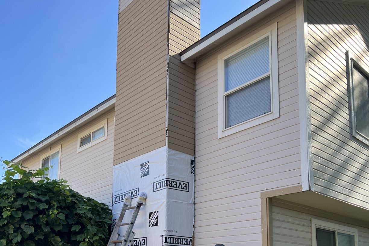 Chimney siding repair wrapped and prepped