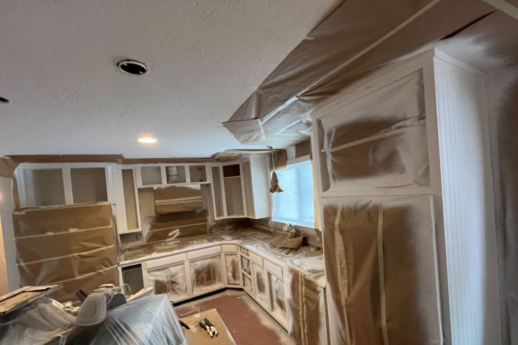 Kitchen cabinets masked and prepped for spraying