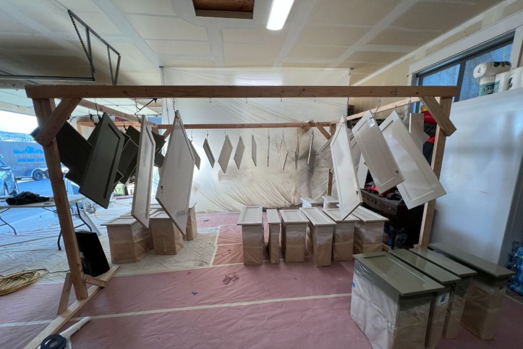 Cabinet doors hanging in paint workspace