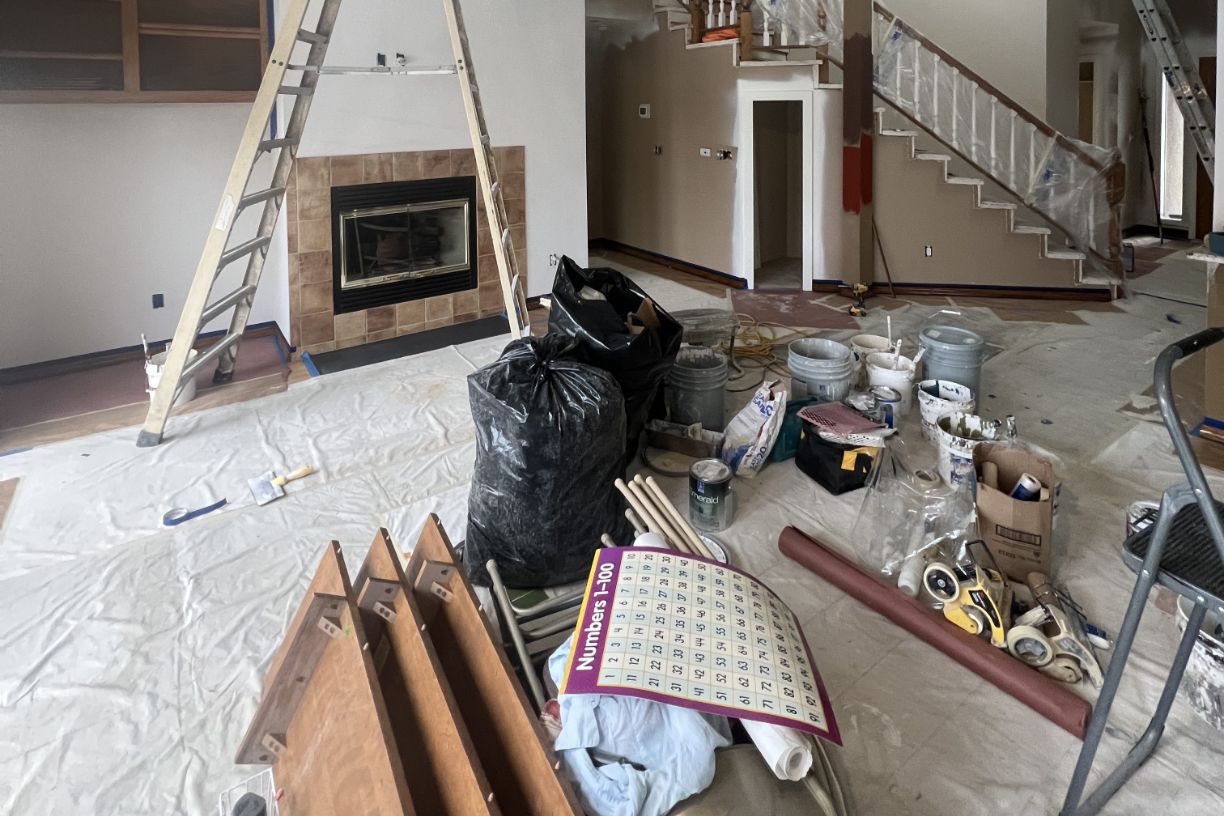 Living room filled with painting supplies