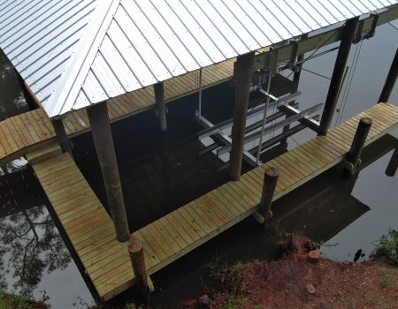 Wooden dock construction beside calm water