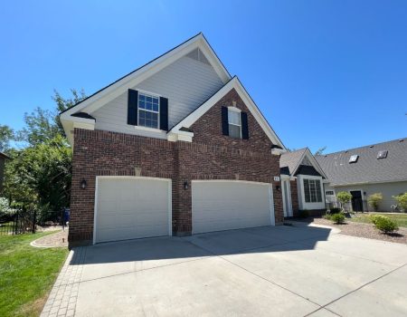 Brick exterior home with clean driveway